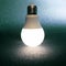 Led bulb included on a dark background. everyday household item in electricity