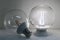 A led glass transparent lamp classic ball form is on and a led glass transparent lamp with an orange leds is off on white