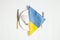 LED light bulb and the flag of Ukraine lie on a dinner plate and next to a knife with a fork on a white background, power outages