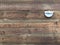 LED light bulb powered by a solar panel hangs on a wall made of untreated wooden planks. Environmentally friendly construction