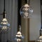 LED pendant lights with round glass balls, brass sockets, glowing, hanging from the ceiling 1x1