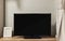 LED TV with blank black screen on built in shelf in living room