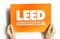 LEED - Leadership in Energy and Environmental Design acronym on card, abbreviation concept background