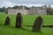 Leeds Castle near Maidstone in Kent, UK, photographed on a crisp, clear day in autumn with three old graves in the foreground.