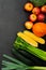 Leek, zucchinis, celery, corn, pumpkin, apples and broccoli on the black background.