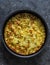 Leeks, potatoes, zucchini frittata on a dark background, top view. Delicious appetizer, tapas, breakfast