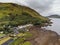 Leenaun, Ireland - 07/16/2020: Aerial view on Leenaun hotel by Kilary fjord. Cloudy sky. Part of Wild Atlantic Way route