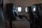 Left armchairs in a business class plane. TV monitors built-in chairs.