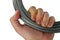 Left hand of adult male person holding coiled 3 mm steel rope used for construction