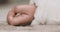 A left hand of sleeping asian baby on the carpet handheld