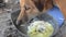 Left over food placed on broken metal pan for hungry brown female dog to eat