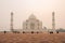 Left side of the Taj Mahal in Agra, India, on overcast morning with smog