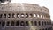 Left to right pan shot of Colosseo in Rome. The Colosseum also known as the Flavian Amphitheatre, an oval amphitheatre