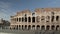 Left to right Timelapse pan shot of traffic nearby the Colosseo in Rome. The Colosseum also known as the Flavian