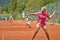 Lefthanded Female teenage tennis player hitting a forehand