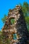 Leftovers of stone block building in summer green meadow