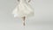 Leg ballerina close-up. ballerina is spinning in a light flying dress on a white background. slow motion