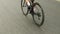 Leg of female cyclist pushing pedals on bicycle. Bicycle wheel and bike gear in motion. Triathlon woman cycling. Woman triathlete