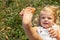 Leg of a little girl with a flower. happy blonde playing with a flower.