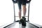 Leg of man running on treadmill in the gym which runner athletic by running shoes. on  white background Health and sport