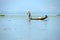 Leg rowing fisherman sets his nets