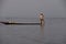 Leg rowing fisherman sets his nets