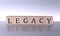 LEGACY concept, wooden word block on the grey background