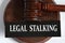 LEGAL STALKING - words on a black sheet against the background of a judge\\\'s gavel