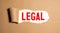 legal. text on white paper on torn kraft cardboard background