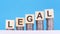 Legal - text on wood cube block stack with coins