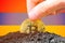 Legalization of bitcoin in Armenia. Planting bitcoin in the ground on the background of the flag of Armenia. Armenia -