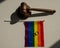 Legalization of same-sex marriages. Rainbow flag wedding rings and judge's gavel.