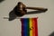 Legalization of same-sex marriages. Rainbow flag wedding rings and judge's gavel.