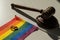 Legalization of same-sex marriages. Rainbow flag wedding rings and judge's gavel.