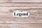 Legend of the word on paper. concept. Words of legend on a wooden background