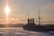 Legendary cruiser Aurora, ice-bound, in the rays of the setting sun on the Neva River, Saint-Petersburg, Russia