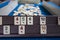 Legendary game okey and game table. Turkish board game Okey Rummikub. A table with green cloth and chips. Hands of the players