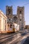 The legendary yellow tram 28 runs in the old town of Lisbon, Alfama, cityscape from Portugal