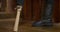 Legless person puts a wooden stick on the floor instead of a leg, imitating a prosthesis, but it is damaged, so it