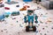 Lego BOOST robot standing on room floor with other Lego toys, bricks and baseplates