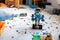 Lego BOOST robot standing in room with other Lego toys, bricks and baseplates