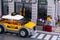 Lego businessman flagging down taxi on city street