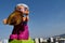 LEGO Duplo toy figure of elder woman with grey hair and pink spectacles frame, holding sliced plum