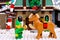 Lego Elf feeding waffle to Reindeer against Elf Club House