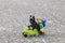 Lego hiker pushing wheel barrow with batman sit on it.