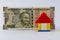 A lego house put in front of one five hundred rupee note representing house loan concept