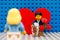 Lego man minifigure with ring and flowers meeting his girlfriend