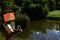 Lego Minecraft action figure of Alex with pickaxe observing landscape around decorative garden pond