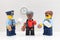 Lego policeman, policewoman and commissioner minifigures drinking coffee and eating donuts in their police office