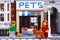 Lego woman with dog and man with red cat  standing near pets shop